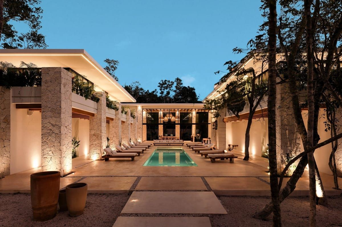 A private estate courtyard at dusk, set for a wedding weekend